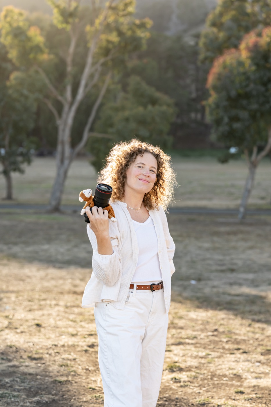 Cass Jens, family photographer for Marin County and San Francisco, with her camera at golden hour