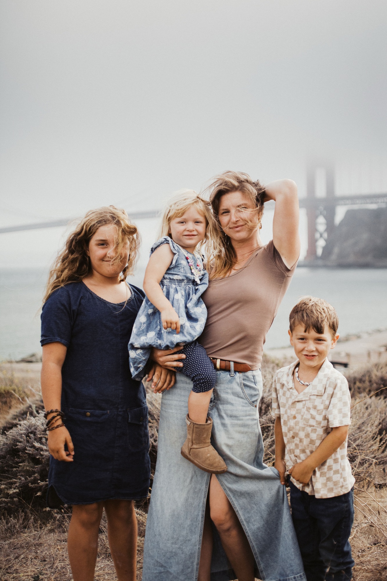 Mom laughing with her three kids on the Marin side of the bay, the Golden Gate Bridge behind them
