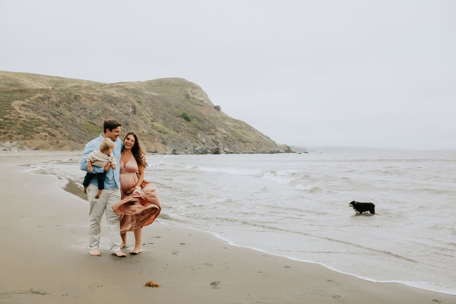 Couple walking along a misty Marin beach