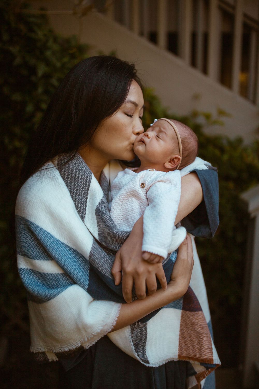 Gentle moments between parent and baby wrapped in white