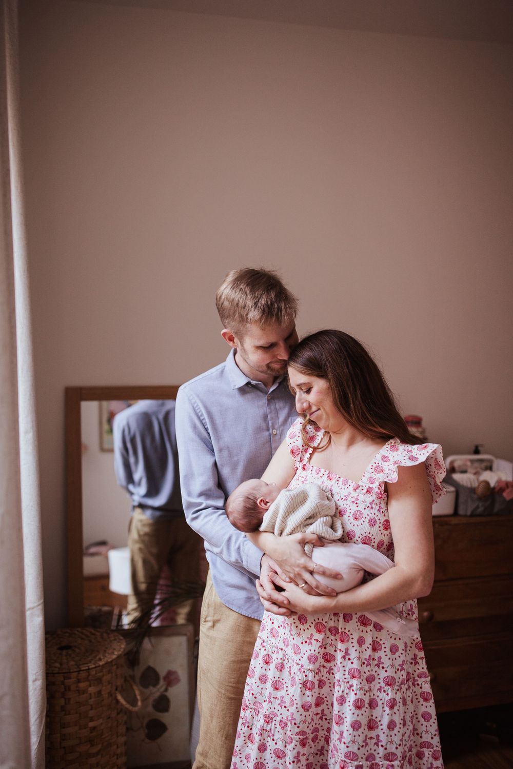 New parents tenderly gazing at their newborn baby