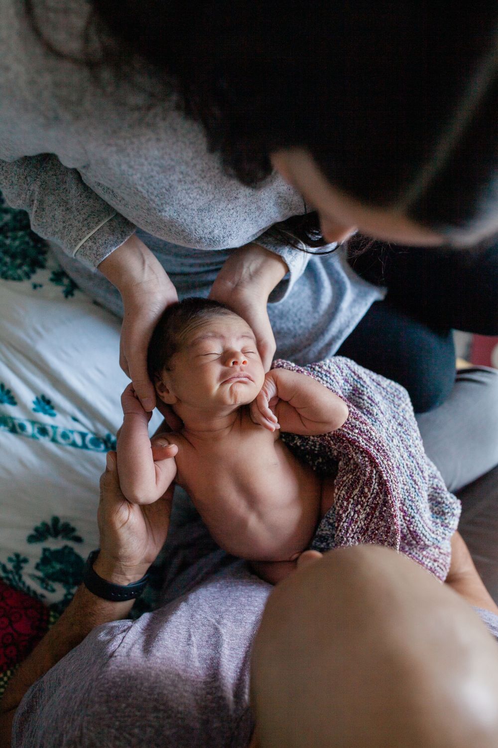 Tender moments between family members during a newborn session