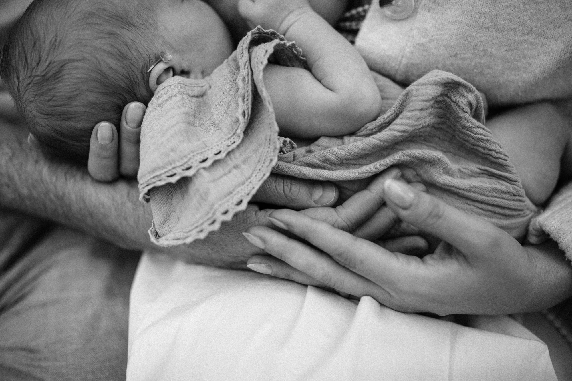 Mother holding her newborn baby during an in-home lifestyle session in Marin County